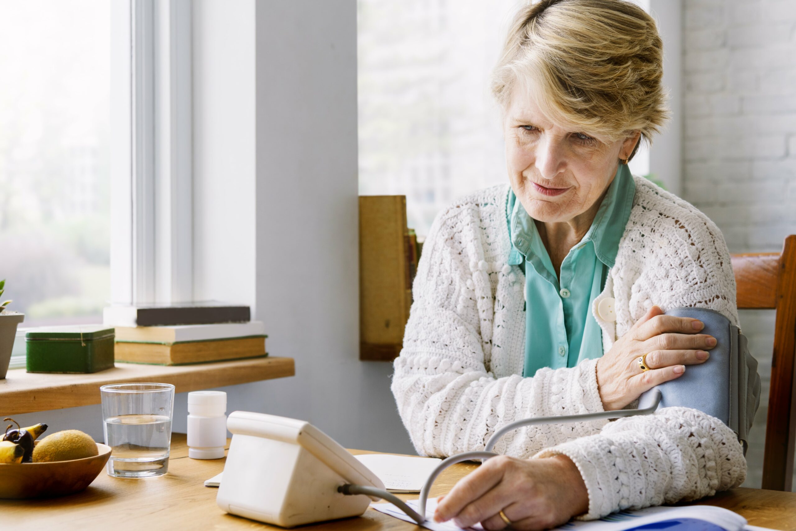 Older woman taking her blood pressure