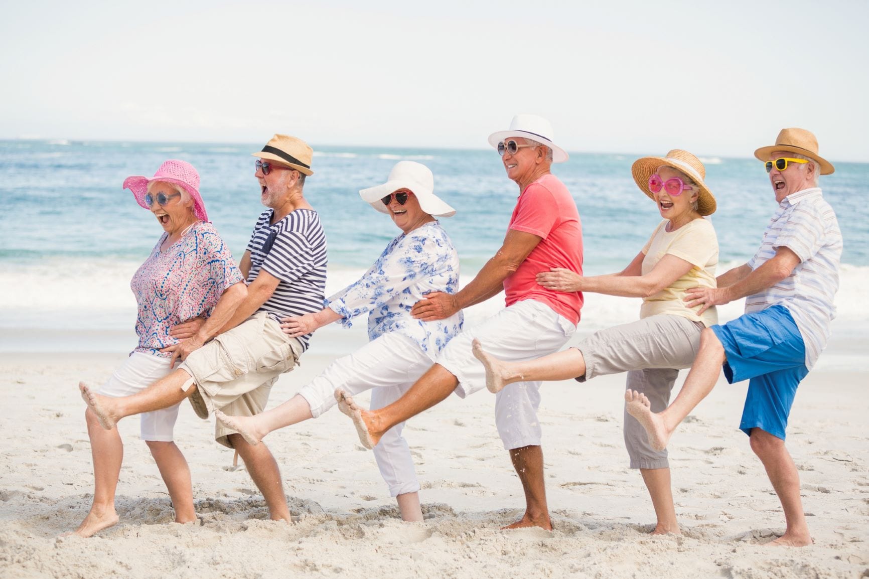 Older adults celebrating on the beach