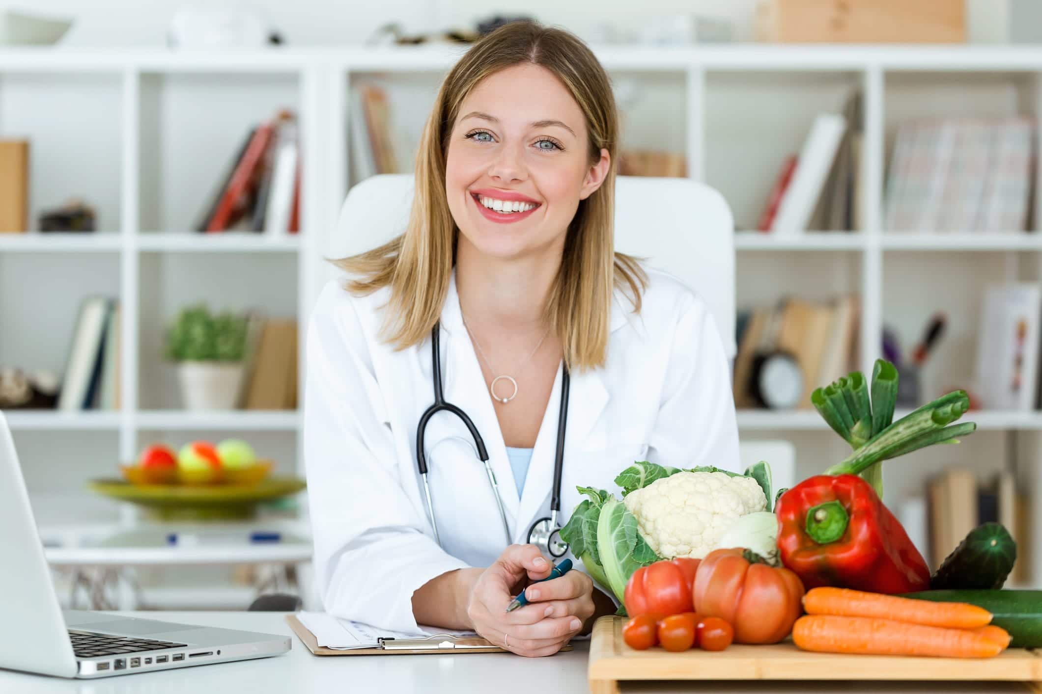 Nutrition professional at her desk with vegetables