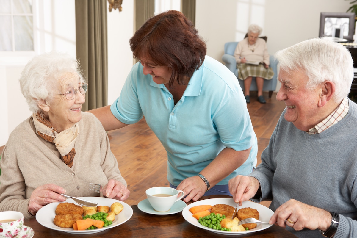 Seniors eating a healthy meal in a nursing home