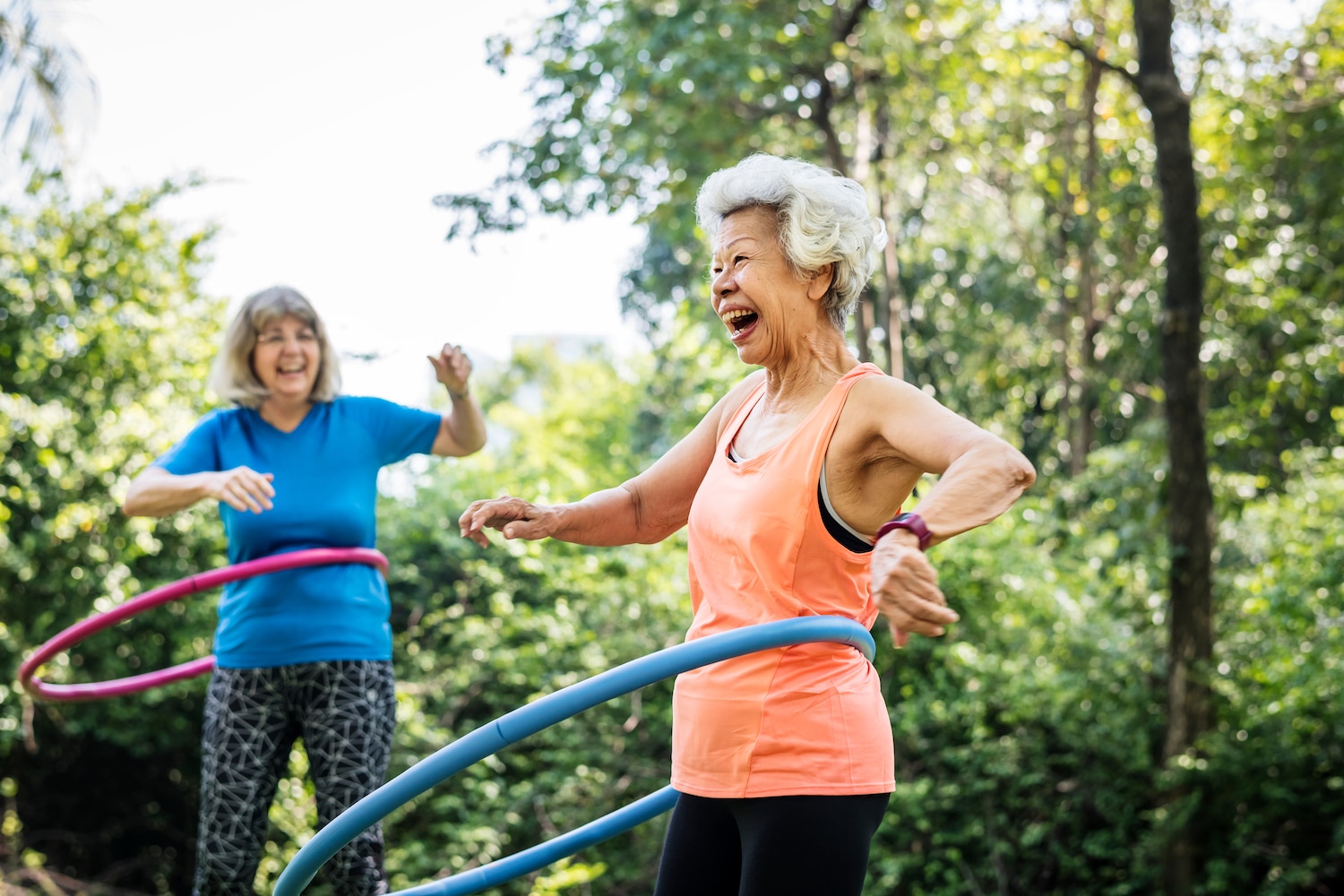 Older women hula hooping in the park