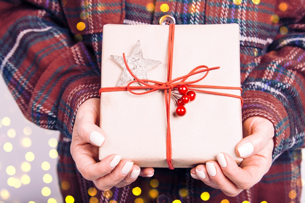 Woman holding small holiday gift