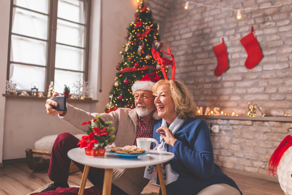 Senior couple on a video call with family to celebrate the holidays