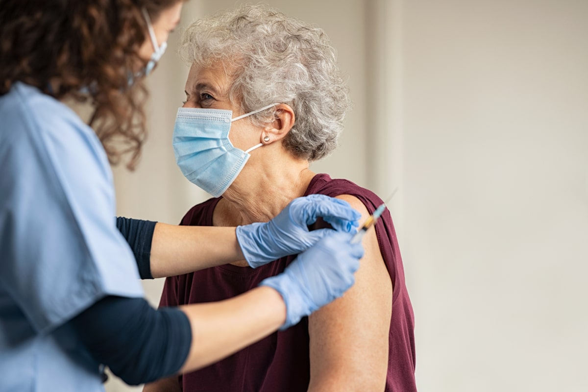 Elderly woman getting COVID-19 vaccine